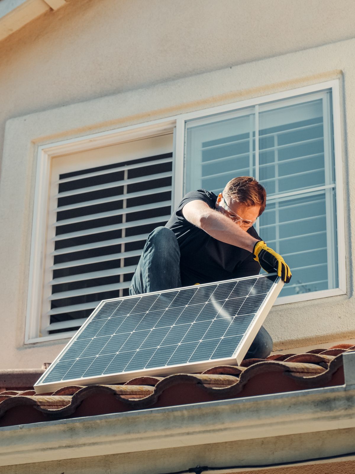 Technician mounting a solar panel