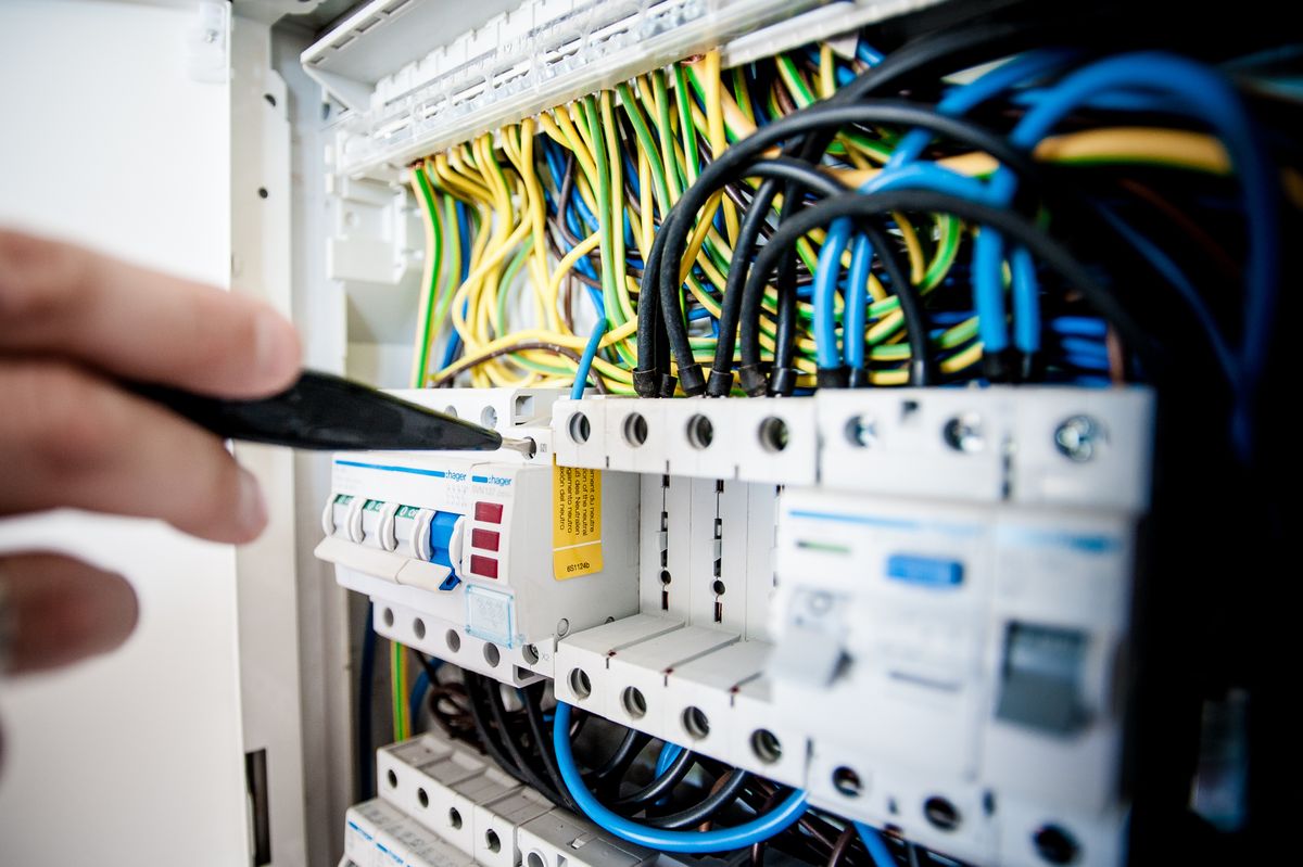 Electrician working on an open switchboard